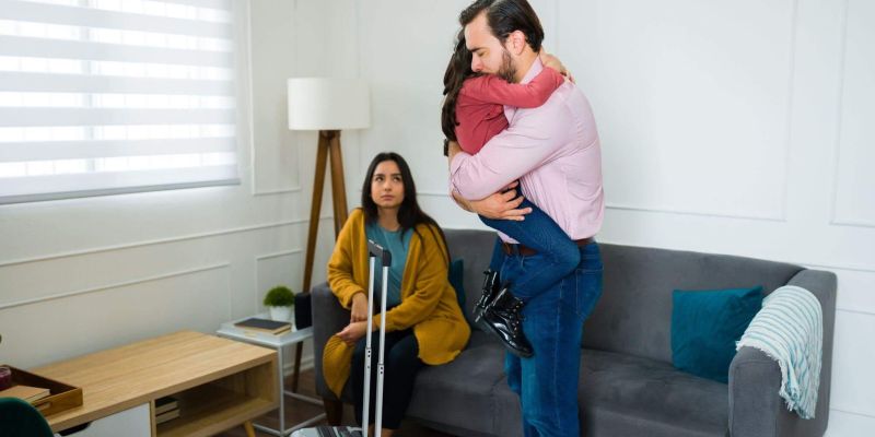 Couple embracing in a living room, symbolizing family change