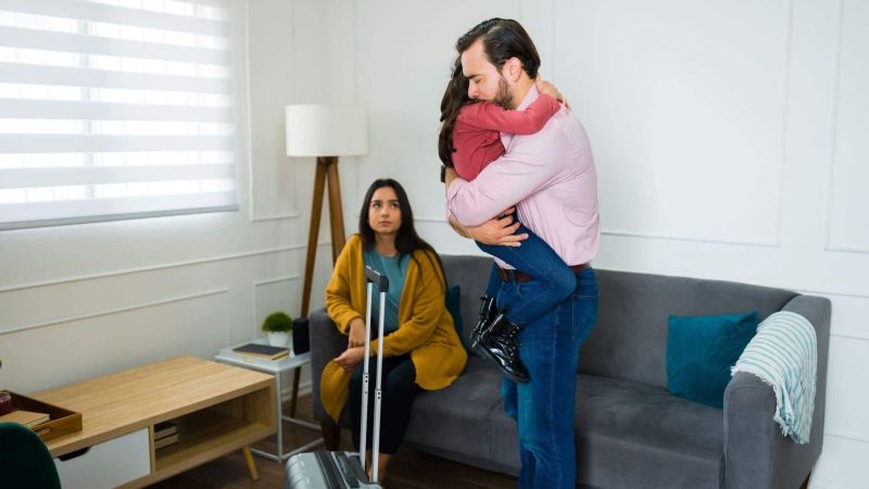 Couple embracing in a living room, symbolizing family change