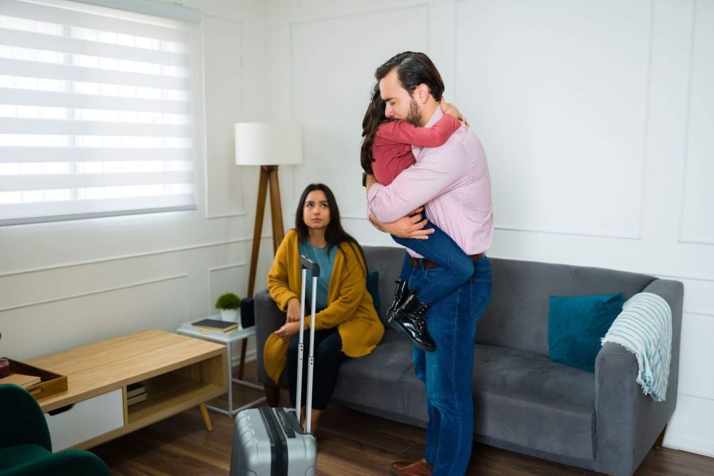 Couple embracing in a living room, symbolizing family change
